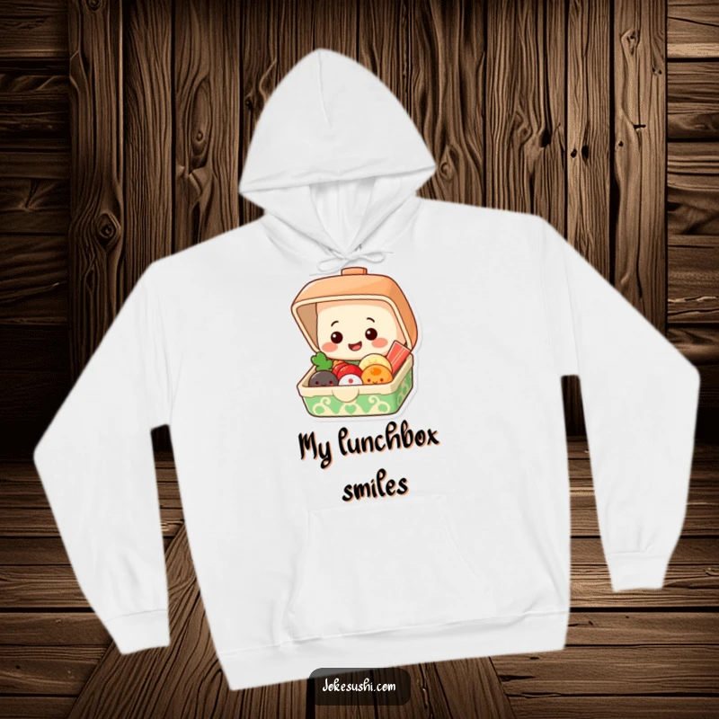 Funny hoodie of a grinning bento box popping open to reveal smiling food items, cozy and cheerful.
